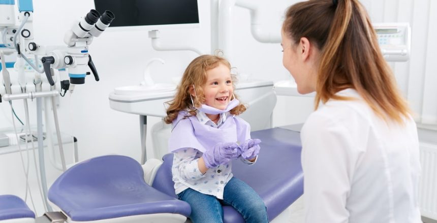 Adorable-little-girl-looking-into-medic-mouth-Pediatric-Dentist-Calgary-NW